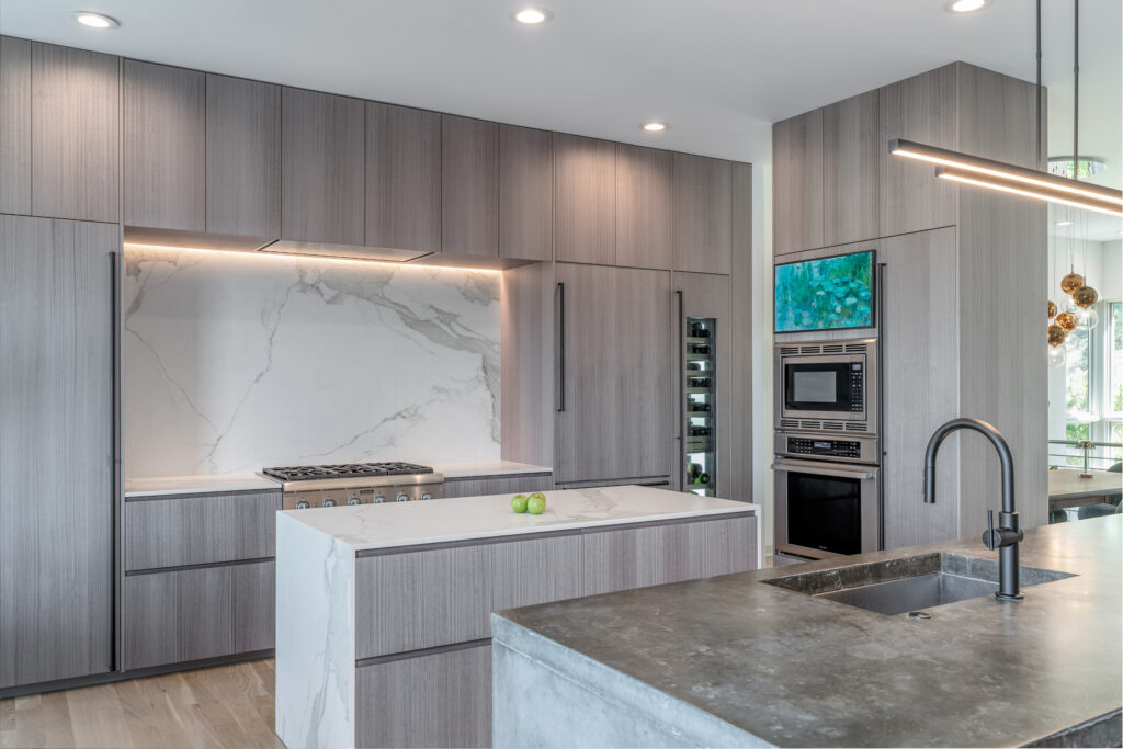 Soffit mounted kitchen hood that highlights a large kitchen backsplash