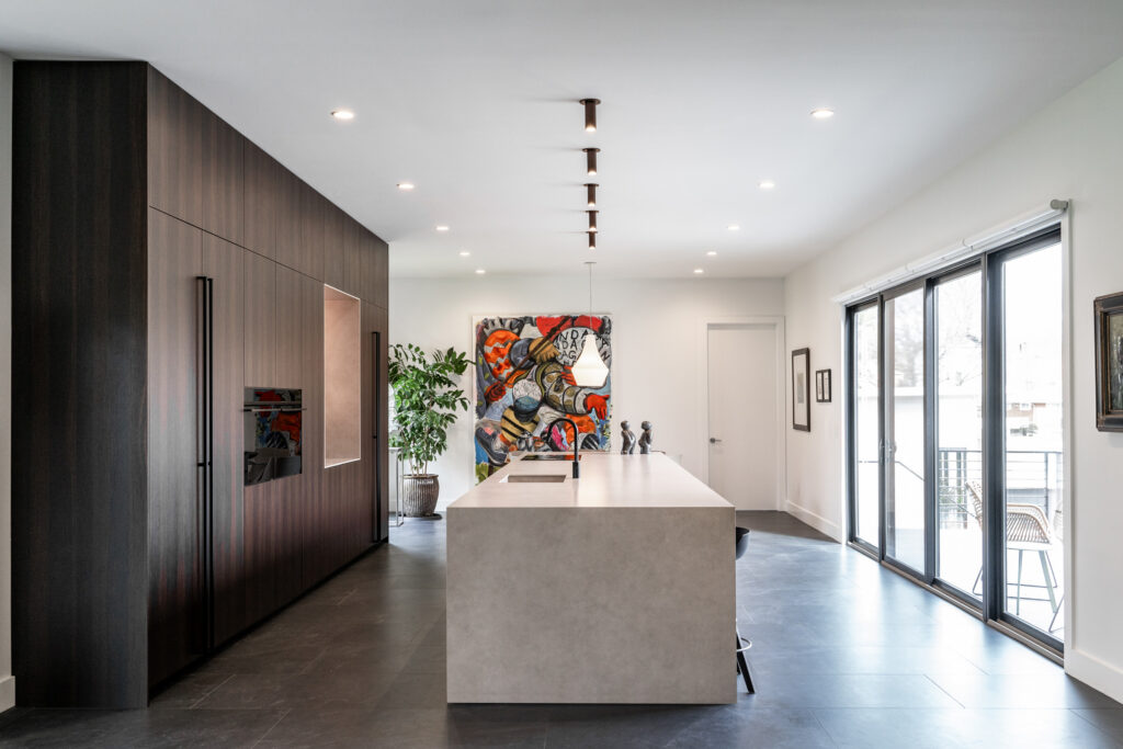 Modern kitchen featuring integrated cabinetry and a sleek design, exemplifying award-winning kitchen design principles with a focus on aesthetic beauty and practical living.