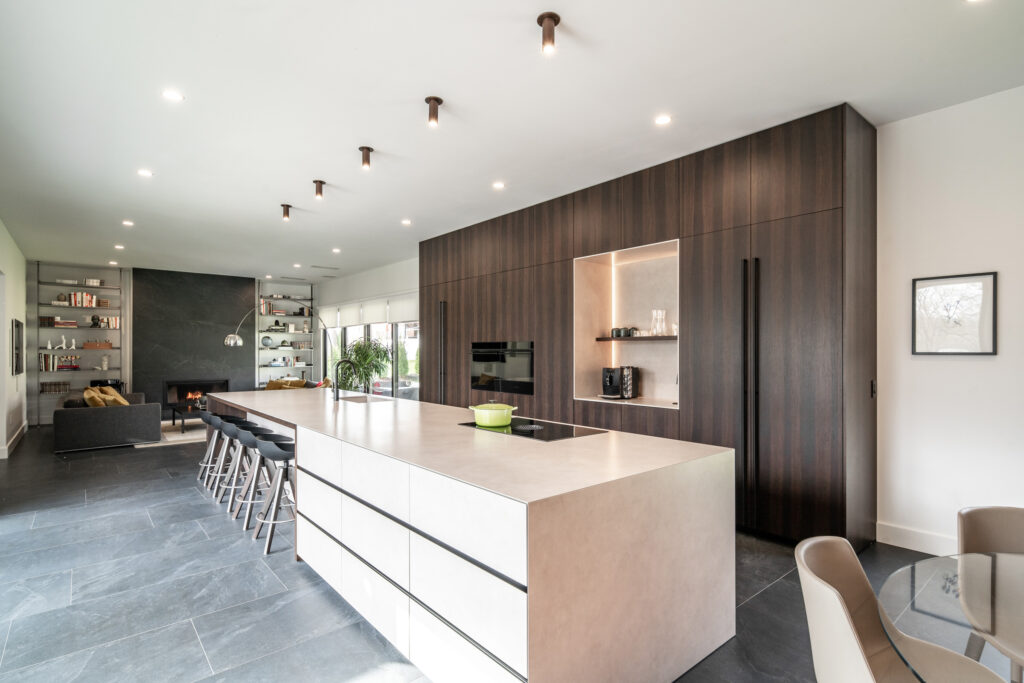 Modern kitchen in Covington, Kentucky that offers a seamless transition from the kitchen, to the dining-space to the living room.