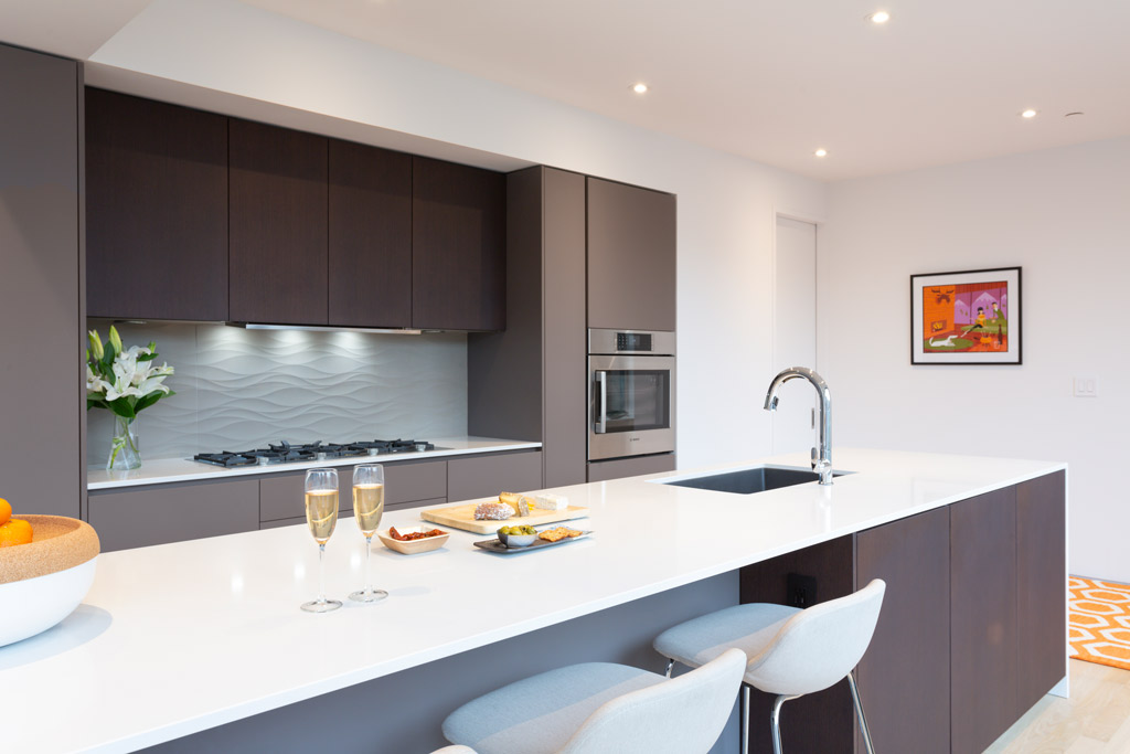 Modern kitchen with kitchen island, integrated seating and tonal grey colors